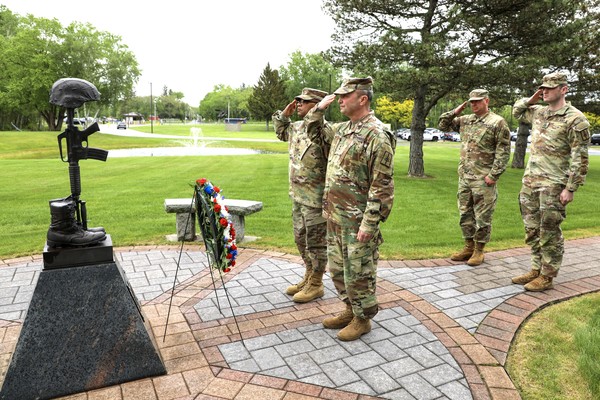 New York Army National Guard Major General Michel Natali, and Command Sgt. Major Edwin Garris, salute as they place a memorial wreath at the fallen warrior memorial outside New York National Guard headquarters in Latham, New York, following a Memorial Day ceremony held on May 22, 2025. Due to poor weather, the ceremony was held in the headquarters lobby. ( U.S. Army NationalGuard photo by Stephanie Butler)