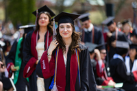 Elyse Triola '26 walks through the Academic Quad on her way to receive her diploma during SUNY Potsdam’s 206th commencement ceremony. 
