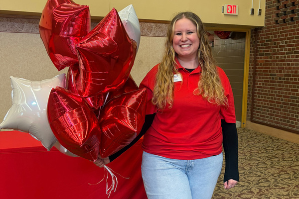 Bailey Clark holds balloons during an admissions event at PennWest.