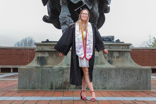 Gianna Slodysko poses for a photo in front of the Fighting Scot statue at PennWest Edinboro.