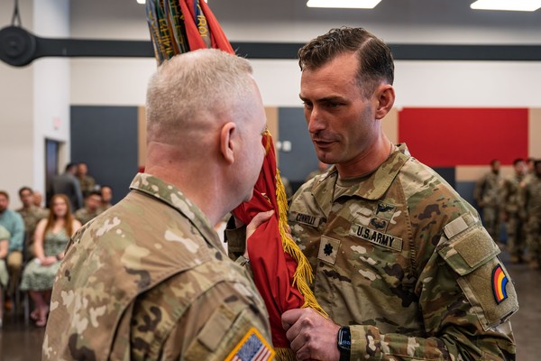 Lt. Col. Adam Connolly, right, accepts the flag of the 1st Battalion, 258th Field Artillery Regiment from Col. Jeffery Roth, commander of the 42nd Infantry Division Artillery, during change of command ceremonies on May 16 at the Jamaica Armory in Queens, New York. ( U.S. Army National Guard photo by Sgt. 1st Class Sebastian Rothwyn)
