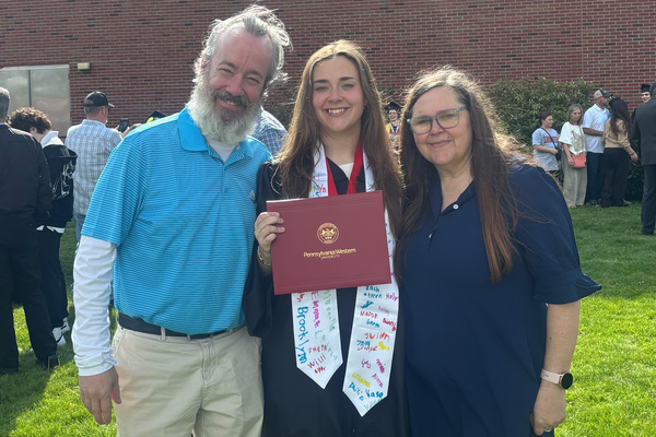 Devin Keidel (center) with Andy and Donna Keidel following the May 9 commencement ceremony.