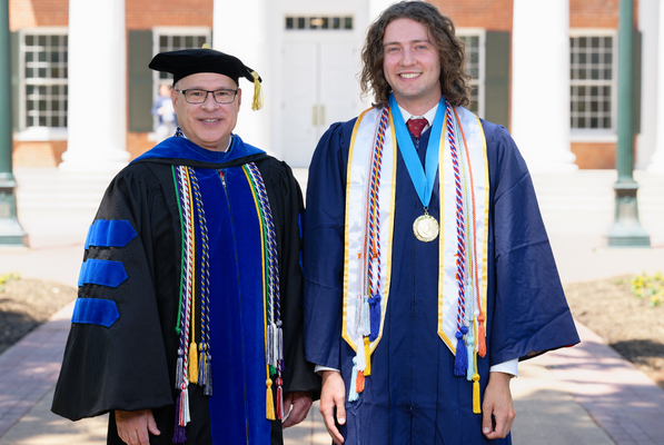 Image of Provost Noel Wilkin and class marshal Glenn Hayden Walker in graduation regalia.

