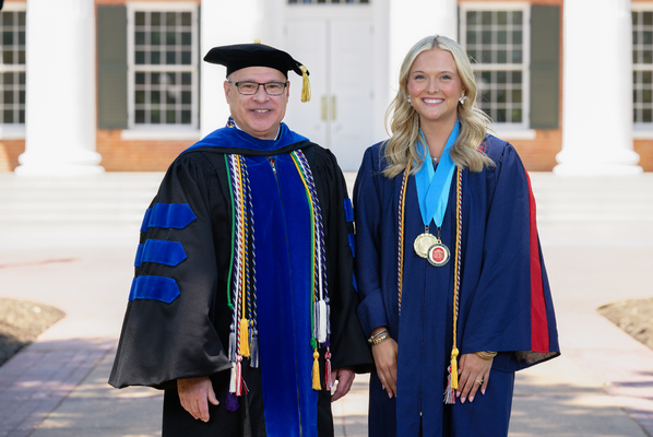 Image of Provost Noel Wilkin and class marshal Sidney Brooke Zinda in graduation regalia.

