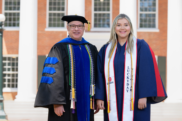 Image of Provost Noel Wilkin and class marshal Sarah Beth Brassfield in graduation regalia.


