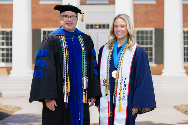 Image of Provost Noel Wilkin and class marshal Rachel Kathryn Rowe in graduation regalia.


