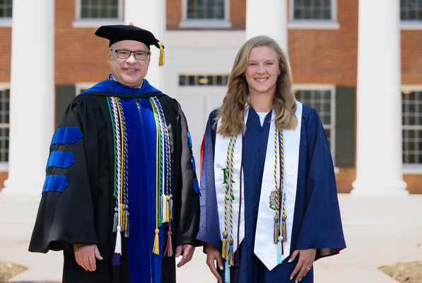 Image of Provost Noel Wilkin and class marshal Ella Callaway Scroggins in graduation regalia.

