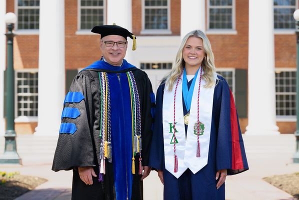 Image of Provost Noel Wilkin and class marshal Ashley Taegan Duke in graduation regalia.

