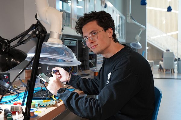 MTSU student welding a circuit in the Applied Engineering Building lab