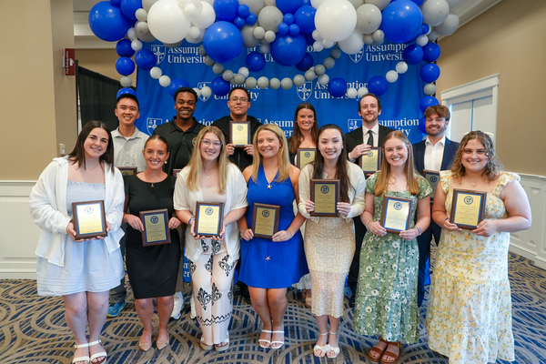 Assumption University's 2026 Emmanuel D'Alzon Crown and Shield Award Recipients pose in a group with their plaques. 