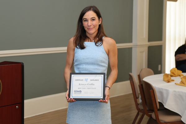 Student poses with award certificate