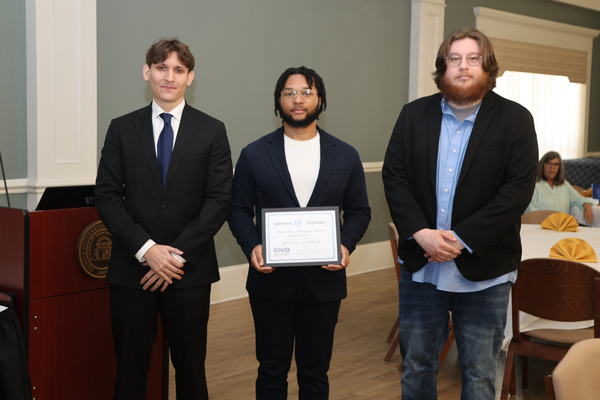 Students pose with award certificate