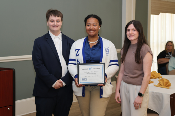 Students pose with award certificate
