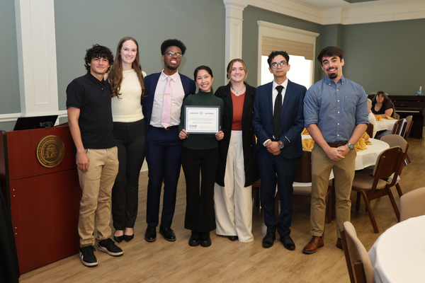 Students pose with award certificate