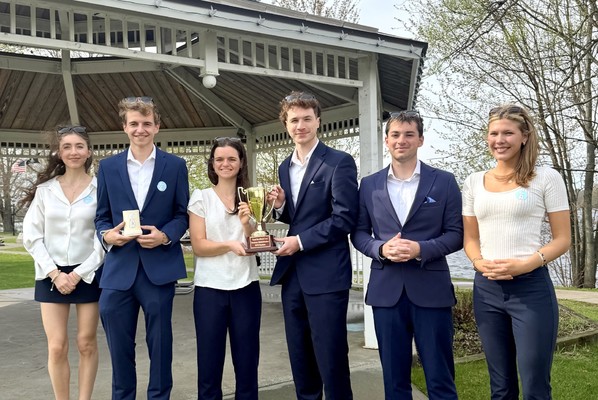 From left, Diana Vashchenko '26, Luis Tito ‘26,  Adrianna Orlando ‘27,  Jayden Murphy  ‘27, Matthew Mapes ’27 and Jaidan Kertenis ‘26 pose with the winning trophy after winning the 64th Business Plan Competition at SUNY Potsdam.