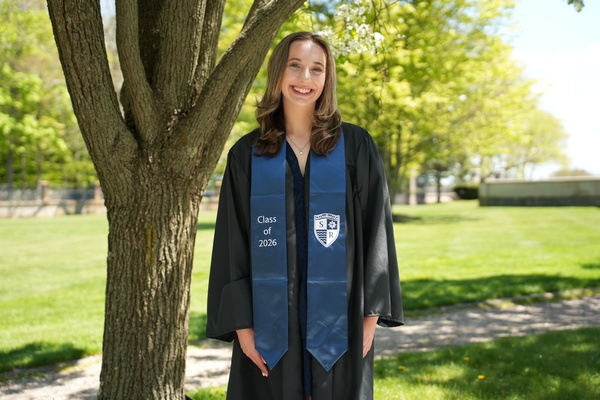 Representation of the achievement named 'Olivia Augustine graduates as valedictorian at Salve Regina University'.