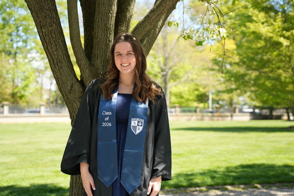 Representation of the achievement named 'Watertown's Emalyn Osborne graduates as Salve Regina University valedictorian, prepares for teaching career'.