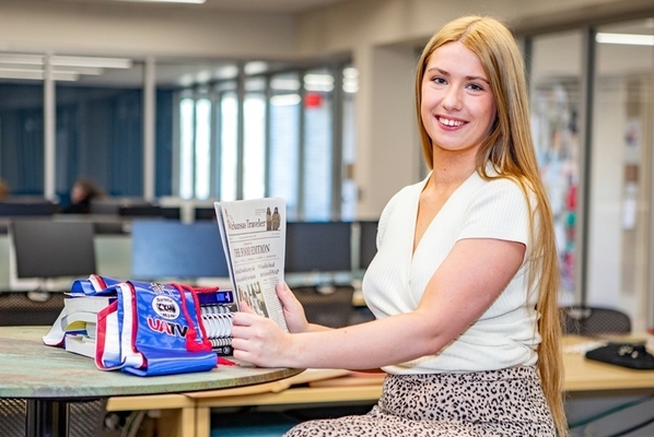 student sits in computer lab presenting work