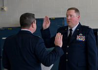 Two Air Force Officers, one administering oath to another.