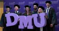 DMU students celebrating on their commencement day at Casey's Center in Des Moines.