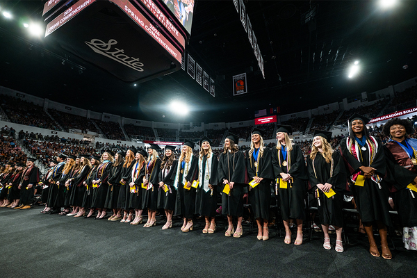 Graduates on the front row stand during commencement ceremonies at MSU to be recognized as Stephen D. Lee Scholars for achieving a 4.0 GPA.