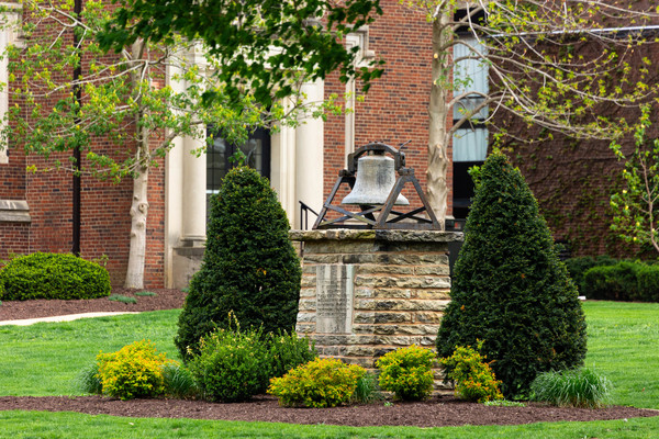 The hedding bell by the entrance to the Eckley Quadrangle by Presser Hall on a spring day.
