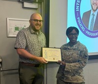 Civilian receives certificate from female two-star general