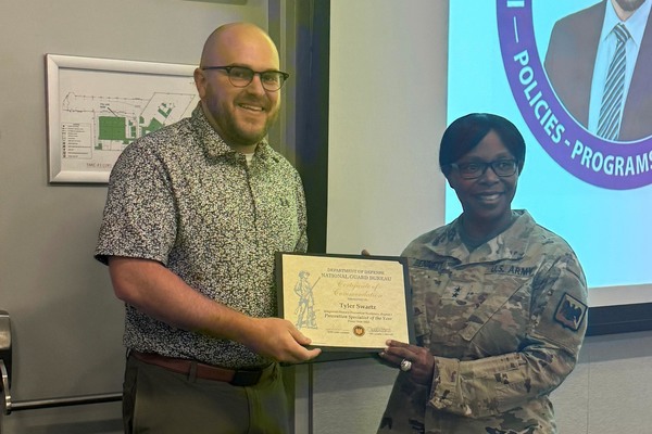 Tyler Swartz, a New York National Guard civilian employee from Syracuse, receives the National Guard Annual IPPW Recognition from Major General Lavetta Bennet, the National Guard’s director of manpower and personnel during a May 14, 2026, ceremony at National Guard headquarters in Arlington, Va. Swartz, a National Guard employee for six years, was recognized for this professionalism, innovation and leadership.  