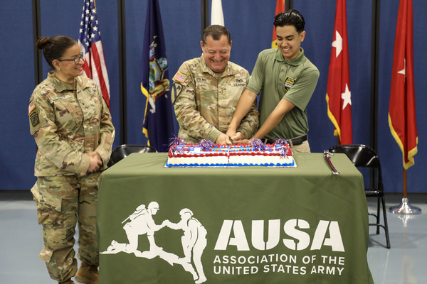 New York Army National Guard Brig. Gen. Isabel Smith watches as Chief Warrant Officer 5 William Solmo (center) joined by Pvt. John Palacios in cutting the Army birthday cake during a June 13, 2024 Army Birthday ceremony held at New York National Guard headquarters in Latham, New York to mark the Army's 250th birthday. Palacios, who is 17, represented the future of the Army, while Solmo, who is 59, represented the history and traditions of the service. (U.S. Army National Guard photo by Stephanie Butler)