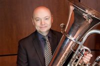 Charles Guy poses for a photo with his tuba at The Crane School of Music.