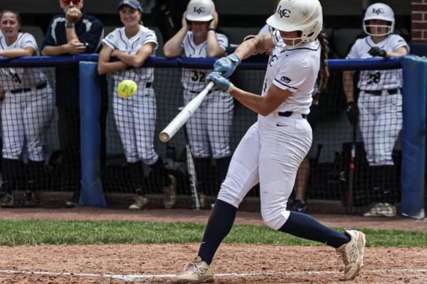 LVC softball player swings and hits the ball