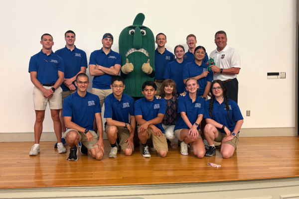 The 2026 cohort of aspiring pilots attending the AFJROTC Flight Academy at DSU this summer are (front row, from left) Tyler Cognitore, Owen Chang, Anthony  Chavez-Ramirez, DSU Aerial Applicator Program Coordinator Sheila Millican, Kendyl Corper, Jonas Dillon-Sauer, (back row, from left) Logan Allen, Joshua Noecker, Forrest Blair, the DSU Fighting Okra, Kane Barnard, Paige Edwards, Jonah Marlow, Julyssa Bautista Mejia and JROTC Representative Dale Lightfoot.    