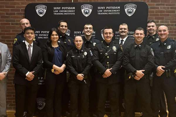 Graduates of the Spring 2026 class at SUNY Potsdam’s Law Enforcement Training Institute gathered for a photo at their graduation ceremony. They included: Front row (from left): SUNY Potsdam University Police Chief Shane Ashley, Josue Escobar of Port Washington (Class of 2027), Franklin County Probation Officer Alexis Fefee, Norwood-Norfolk Police Officer Olivia Huntley, Jefferson County Sheriff's Deputy Nicholas Phelan, St. Regis Tribal Mohawk Police Officer Gavin Benson, Saranac Lake Police Officer Garrett Hutchins, Police Academy Director Sonny Duquette, St. Lawrence County Sheriff's Deputy Cael Woodcock, St. Lawrence County Sheriff's Deputy Nicholas Gregg, Saranac Lake Police Officer Ethan Lavare, Cole Fayette of Potsdam and Jefferson County Sheriff's Deputy Hunter Murphy. 