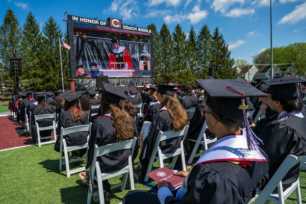 Graduates watch Ole Obermann, global head of music at Apple, deliver Colgate University’s 2026 Commencement address, May 17.