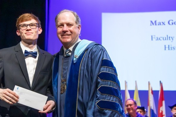 Representation of the achievement named 'Max Gollhofer Honored by Hartwick College'.