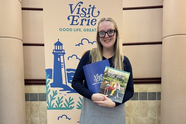 Alison Jones holds promotional materials during her summer internship at VisitErie.