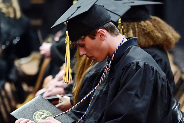 A Northeast Mississippi Community College High School Equivalency graduate looks at his diploma cover during the college's annual High School Equivalency Graduation Ceremony held Monday, May 18, inside Bonner Arnold Coliseum.