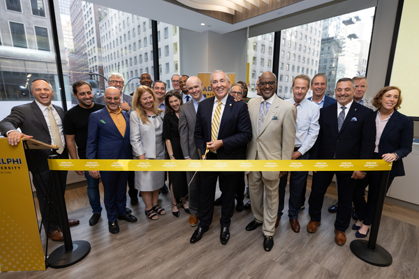 Adelphi President Balboni with members of the board of trustees and executive leadership at the Manhattan Center Ribbon Cutting event.