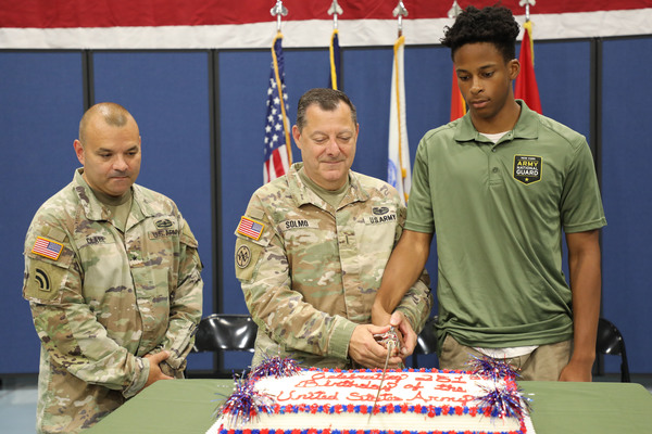 Brig. Gen. Patrick Clare, the director of joint staff for the New York National Guard, looks on as Chief Warrant Officer 5 William Solmo, the oldest Soldier present, joins Pvt. London Brown, at age 17, the youngest Soldier present, in cutting the Army birthday cake during a ceremony at New York National Guard headquarters in Latham, N.Y. on June 12, 2026. The ceremony recognized the Army’s 251st birthday which will be on June 14, 2026. Solmo represented the history and past of the Army while Brown, who enlisted in April, represents its future. (U.S. Army National Guard photo by Lt. Col. Jean Marie Kratzer)
