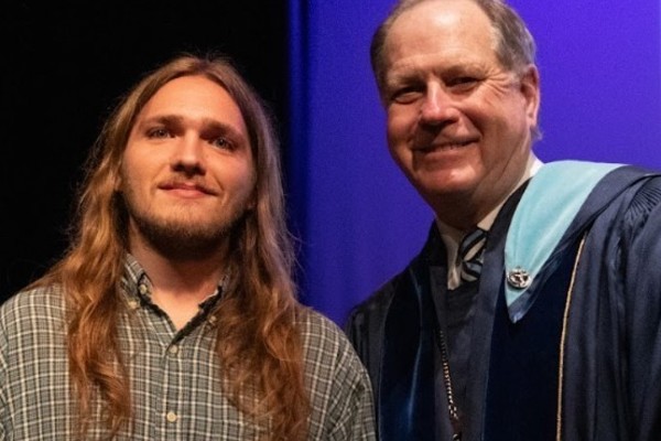 Representation of the achievement named 'Silas Moyer Honored by Hartwick College'.
