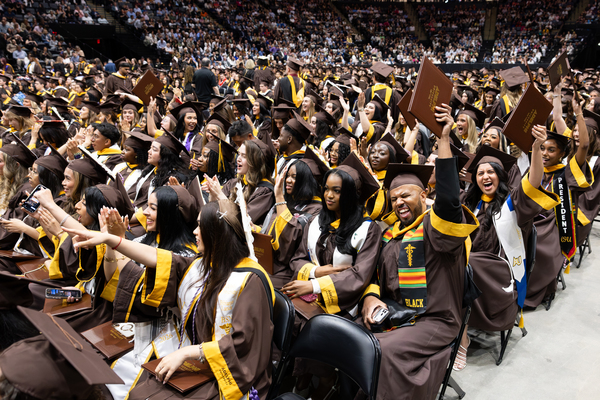 A large group of graduates celebrating at an event.