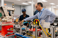 Students and instructor look over equipment at Goodwin program