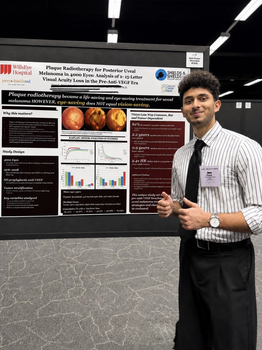 Oam_Patel_standing_with_his_poster_at_conference.jpg