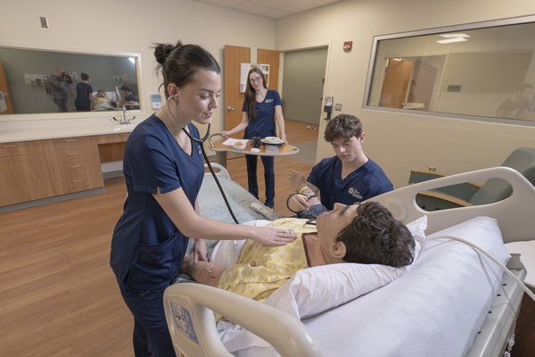 Trine University Associate of Science in Nursing (ASN) students work with a simulated patient in the Joyce and Al Gutstein Education and Innovation Center inside Cameron Hospital in Angola. Trine University is offering select prerequisite coursework at a reduced tuition rate of $150 per credit hour for students planning to apply to the program. (Photo by Dean Orewiler / Trine University)