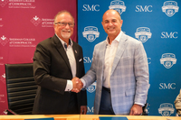 Photo of Sherman and SMC presidents smiling and shaking hands after the articulation agreement signing.