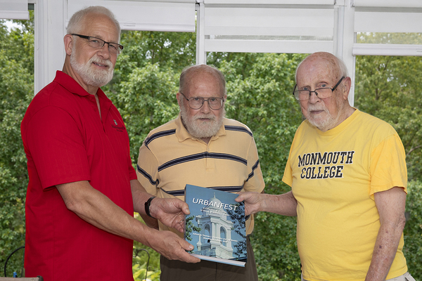 'URBANFEST': William Urban, right, is presented with a copy of Urbanfest, a book published in his honor, by co-editors Jeff Rankin, left, and Thomas Sienkewicz, center.