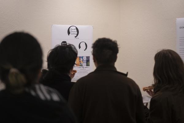 People looking at art on wall