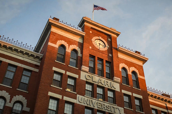 Brick building with clock and flag