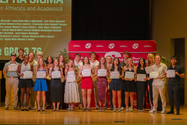 A group of student-athletes pose for a picture. 