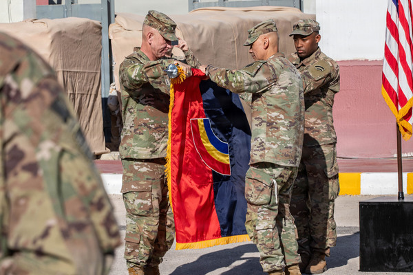 Maj. Gen. Jack James (left) and Command Sgt. Maj. Arnold Reyes (right), the 42nd Infantry Division command team, case the division's colors during the Task Force Spartan transfer of authority ceremony June 6 in the Middle East. The New York Army National Guard's 42nd Infantry Division headquarters served as the command for the Army's Middle Eastern combat element during Operation Epic Fury.(U.S. Army photo)